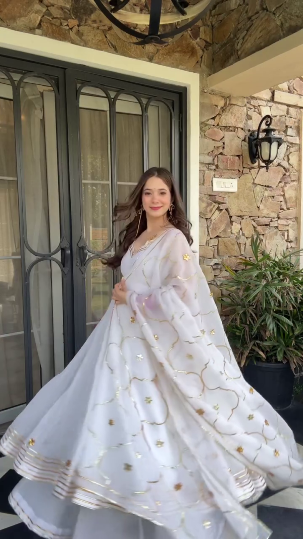 White Georgette Anarkali Suit Set Featuring Golden Embroidered Floral Motifs with Flowing Dupatta, Paired with Traditional Bangles and Statement Earrings – Perfect for Festive Celebrations and Ethnic Occasions